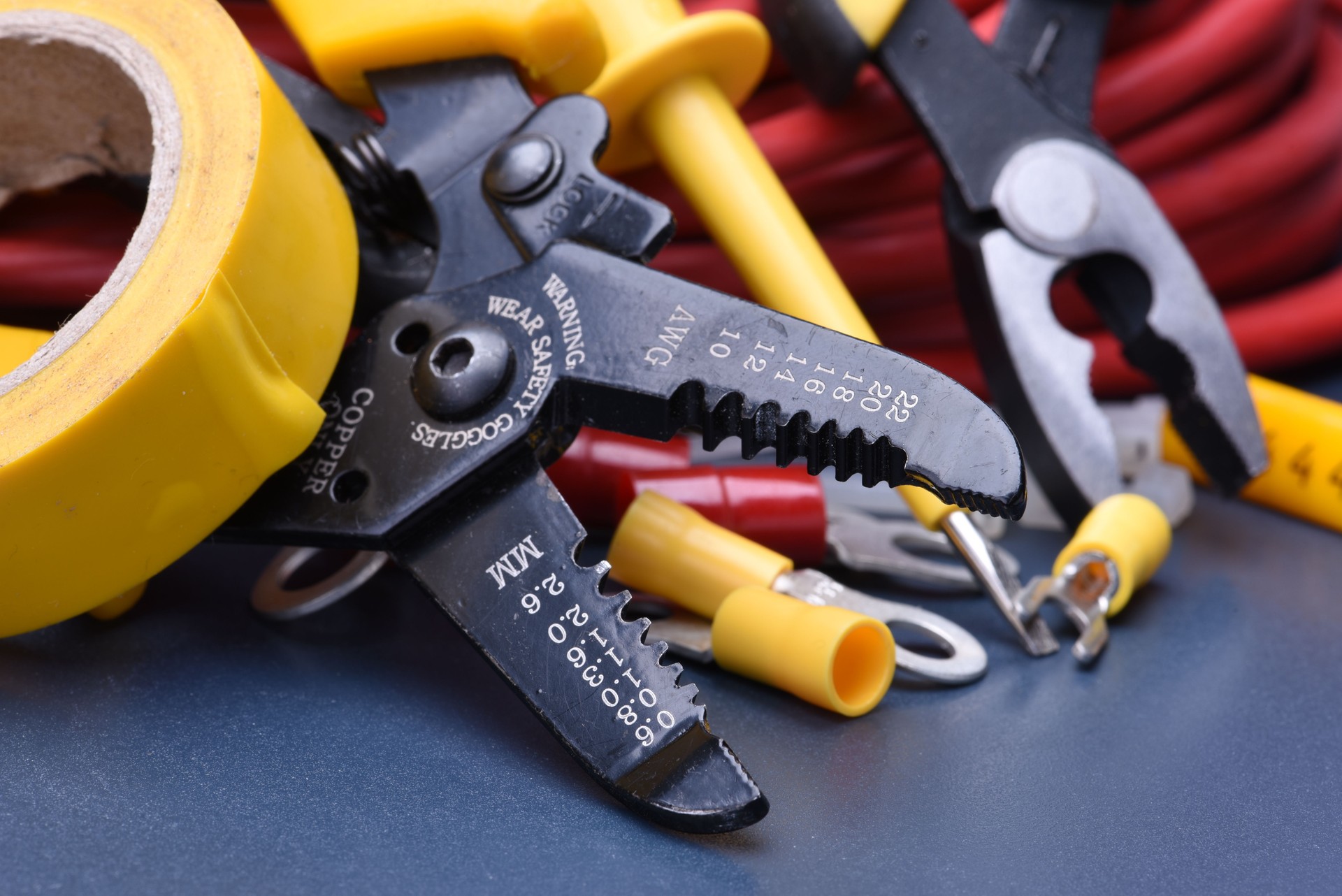 Tools for electrician and cables on metal surface